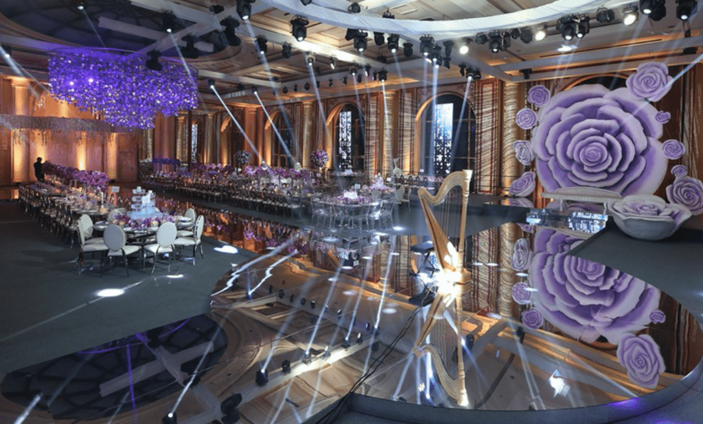 a large room with tables and chairs and purple decorations