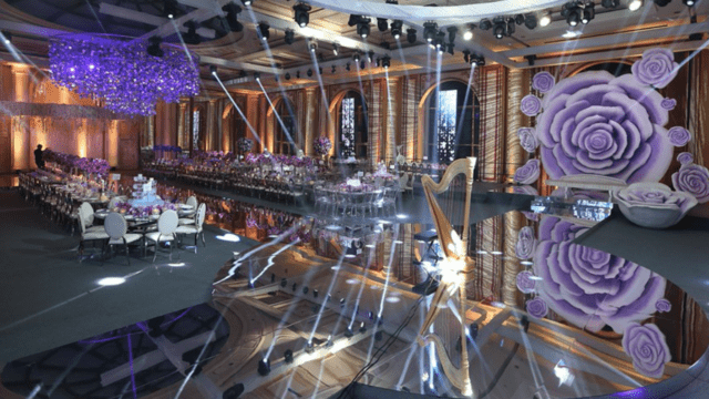 a large room with tables and chairs and purple decorations