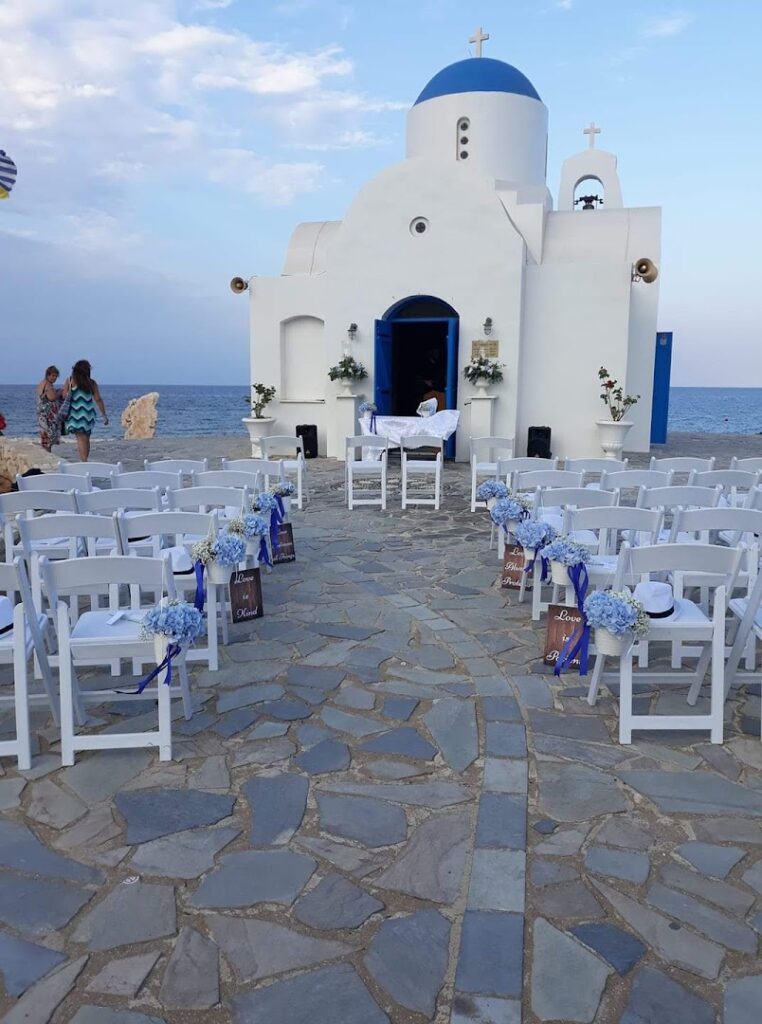 a white church with chairs and flowers