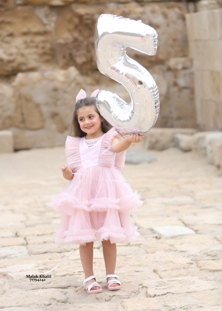 a girl holding a silver balloon