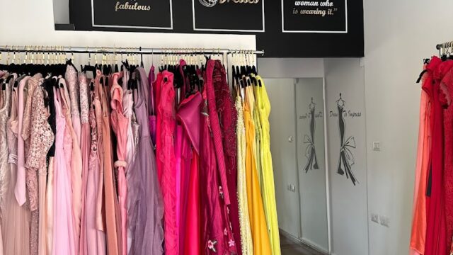 a room with many dresses on swingers