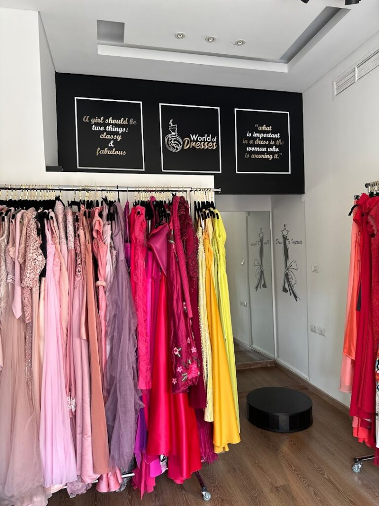 a room with many dresses on swingers
