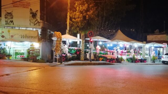 a street with tents and flowers on it