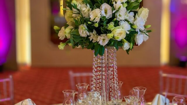 a table set with a vase of flowers