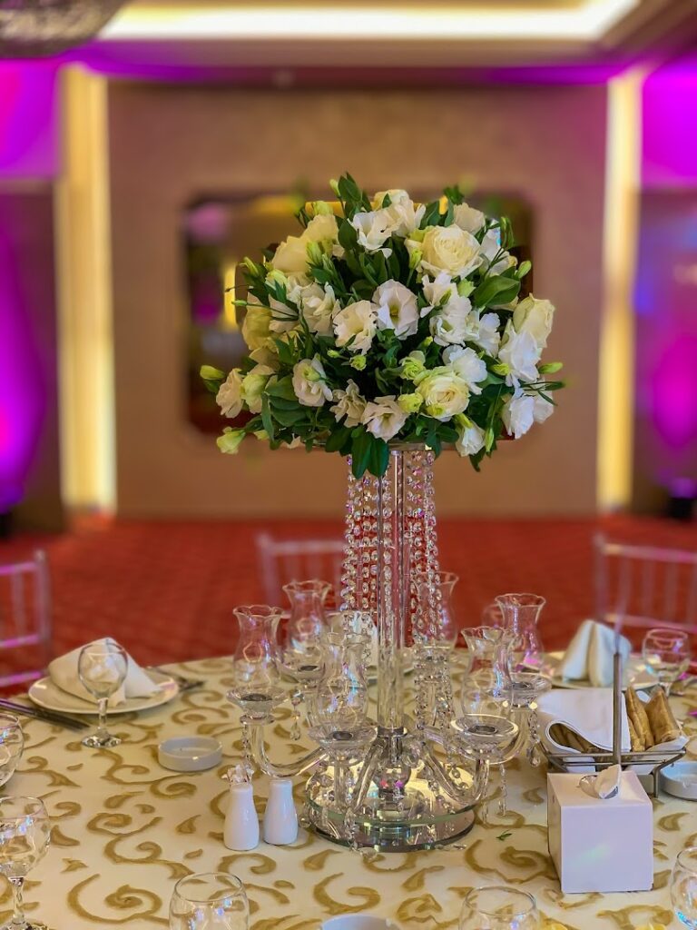 a table set with a vase of flowers