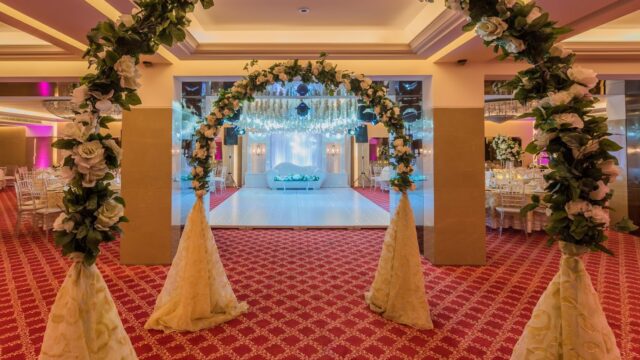 a wedding arch with flowers and a stage