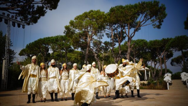 a group of people in white clothing