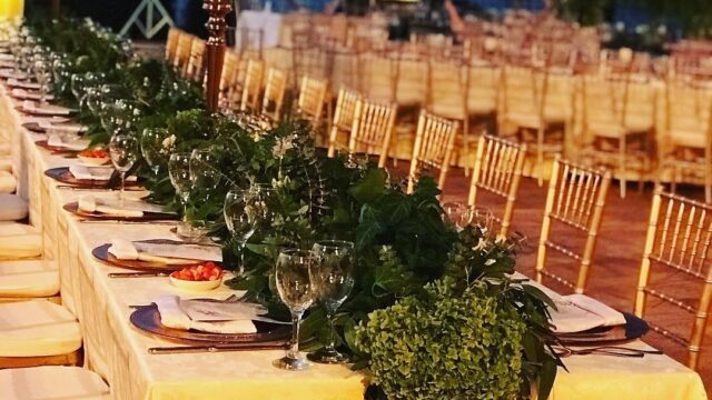 a long table set with candles and flowers