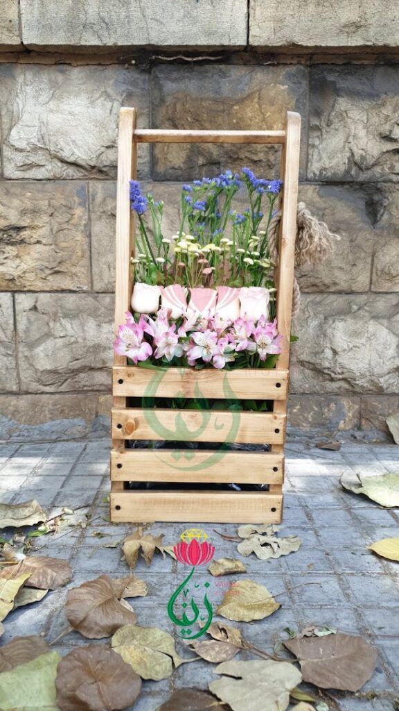a wooden crate with flowers in it