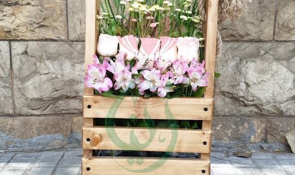 a wooden crate with flowers in it