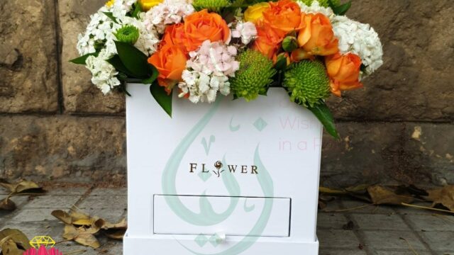 a white box with flowers in it