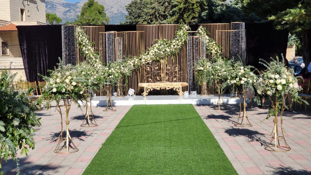 a wedding ceremony area with a bench and flowers