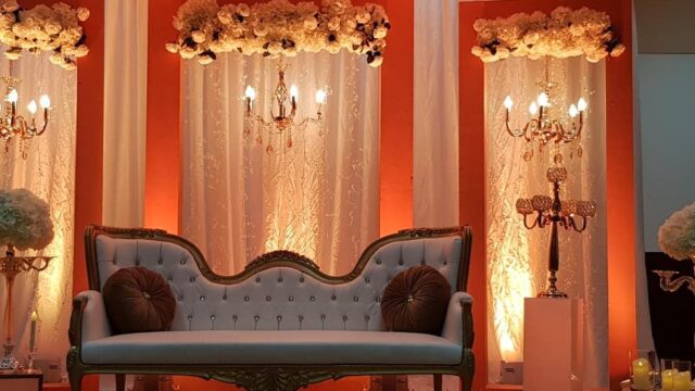 a couch and chandeliers in a room