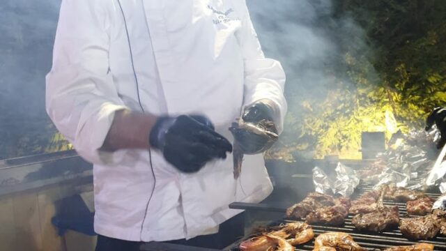 a man cooking food on a grill