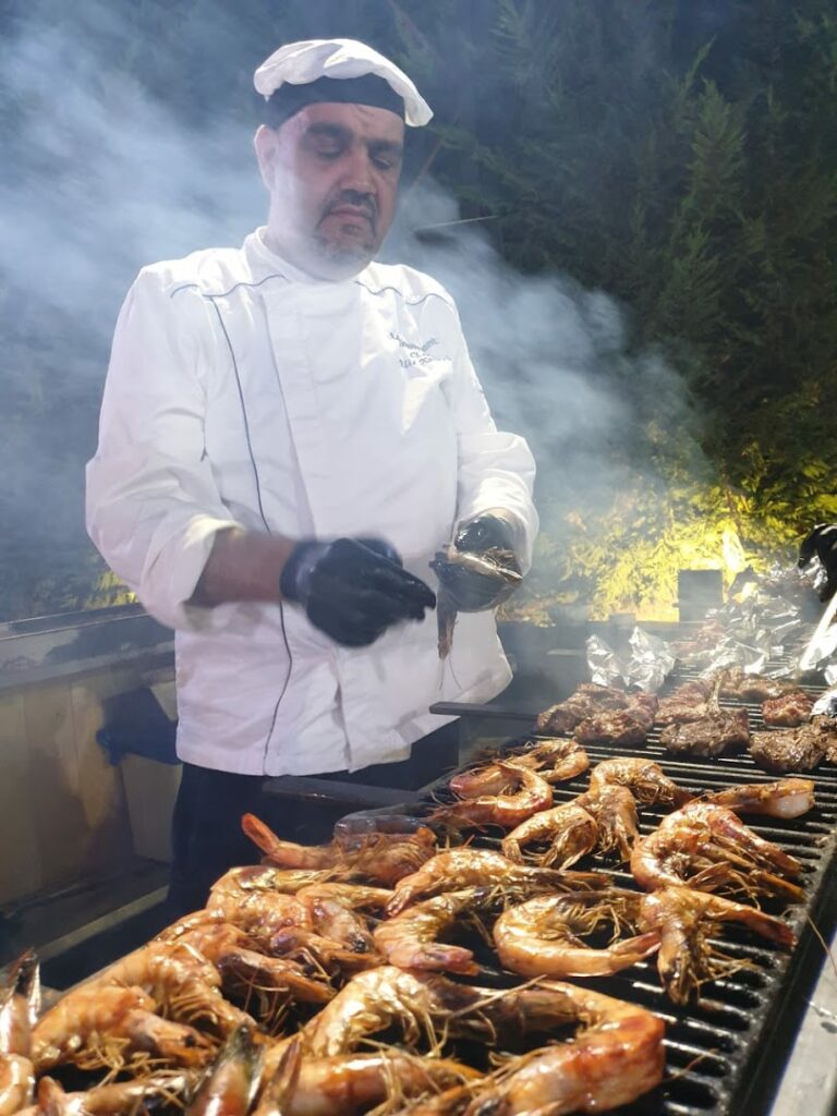 a man cooking food on a grill