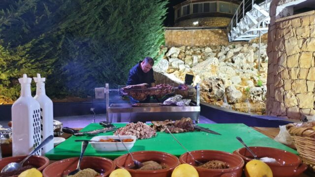 a man cooking food on a grill