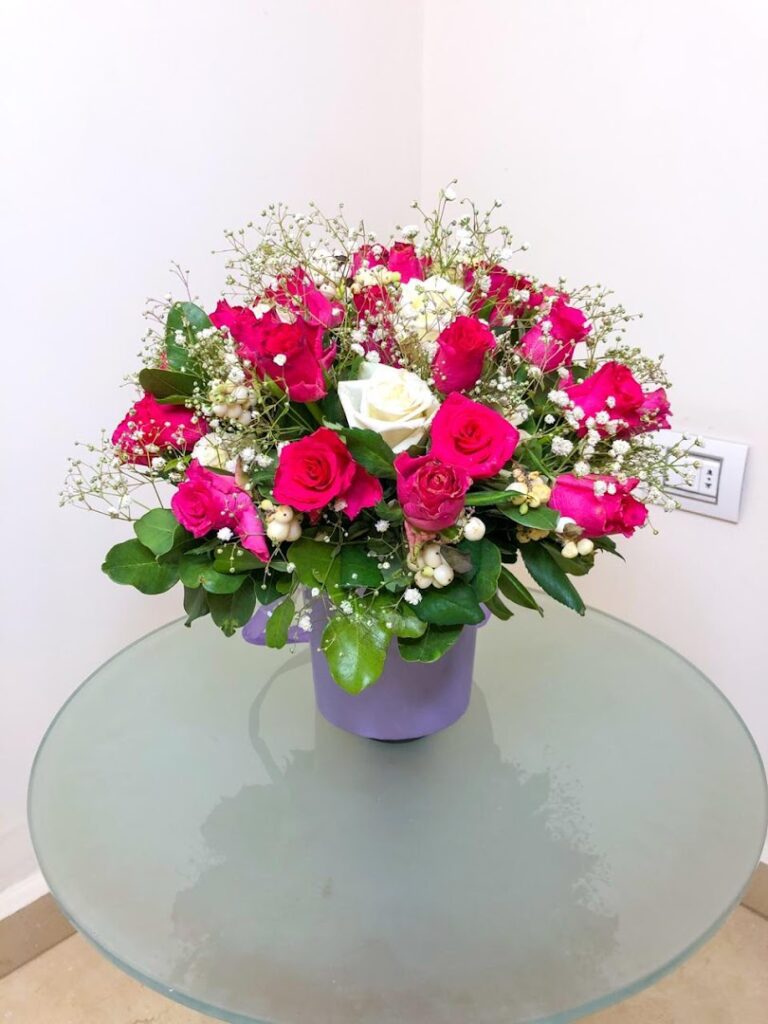 a bouquet of flowers in a purple mug on a glass table