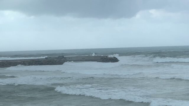 a body of water with waves crashing on it