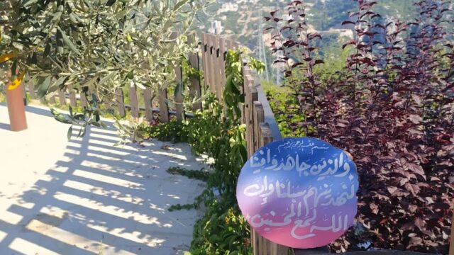 a fence with trees and a sign on it