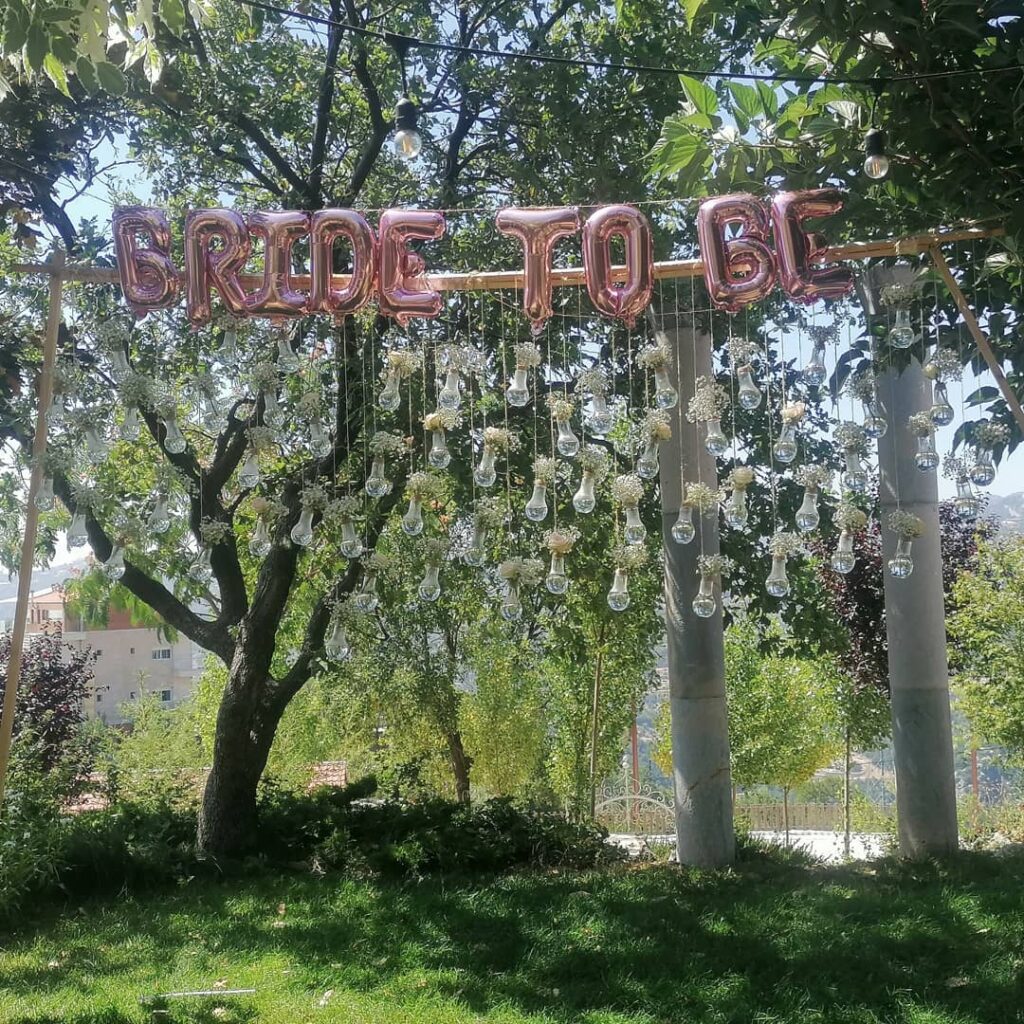 a sign with lights from a tree