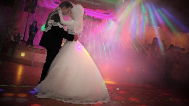 a man and woman dancing on a dance floor