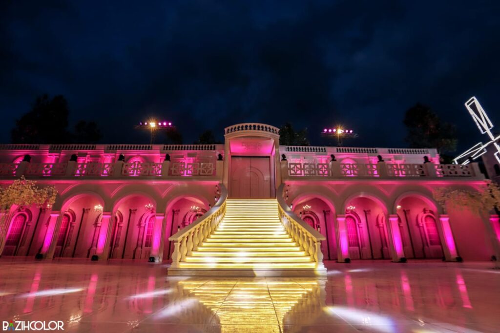 a pink lit up stairs in front of a building