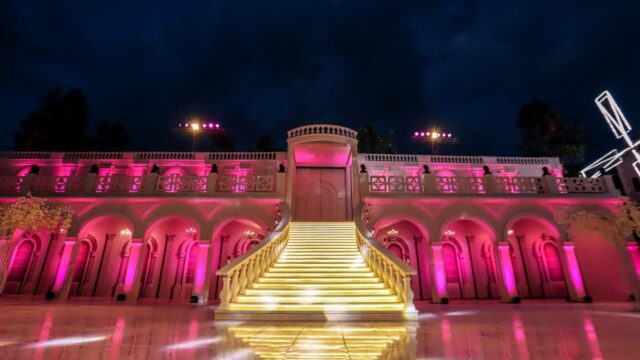 a pink lit up stairs in front of a building