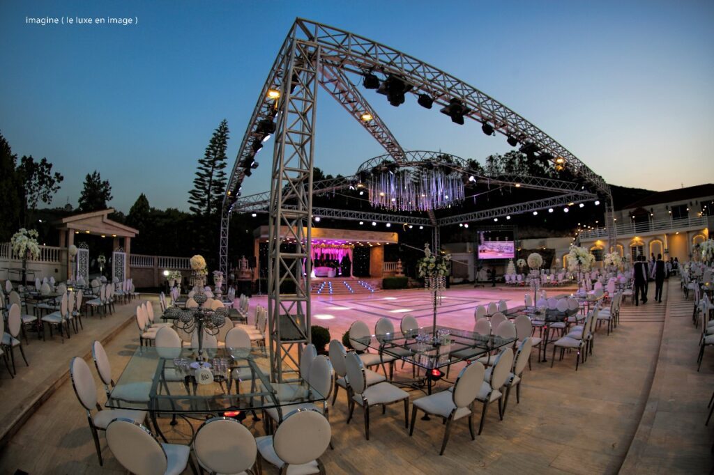 a large outdoor event with a stage and chairs