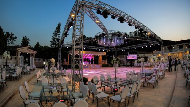 a large outdoor event with a stage and chairs