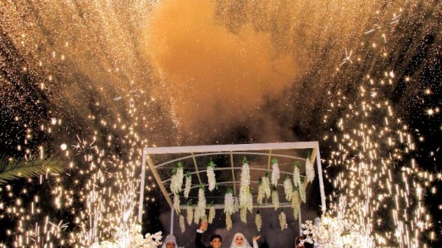 a group of people standing under fireworks