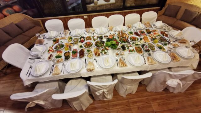 A table with food on it presented by Baskinta Catering.