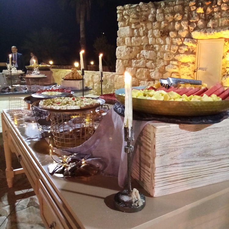 A buffet table with food on it, including Beitrouna.