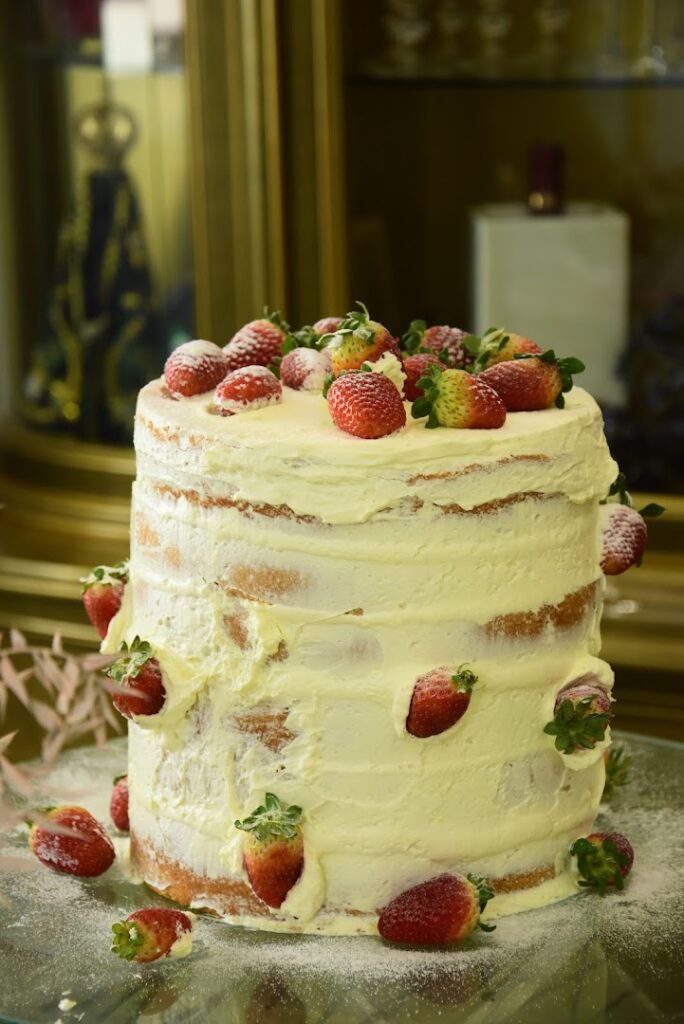 A cake with strawberries on top catered by Bluemz Catering