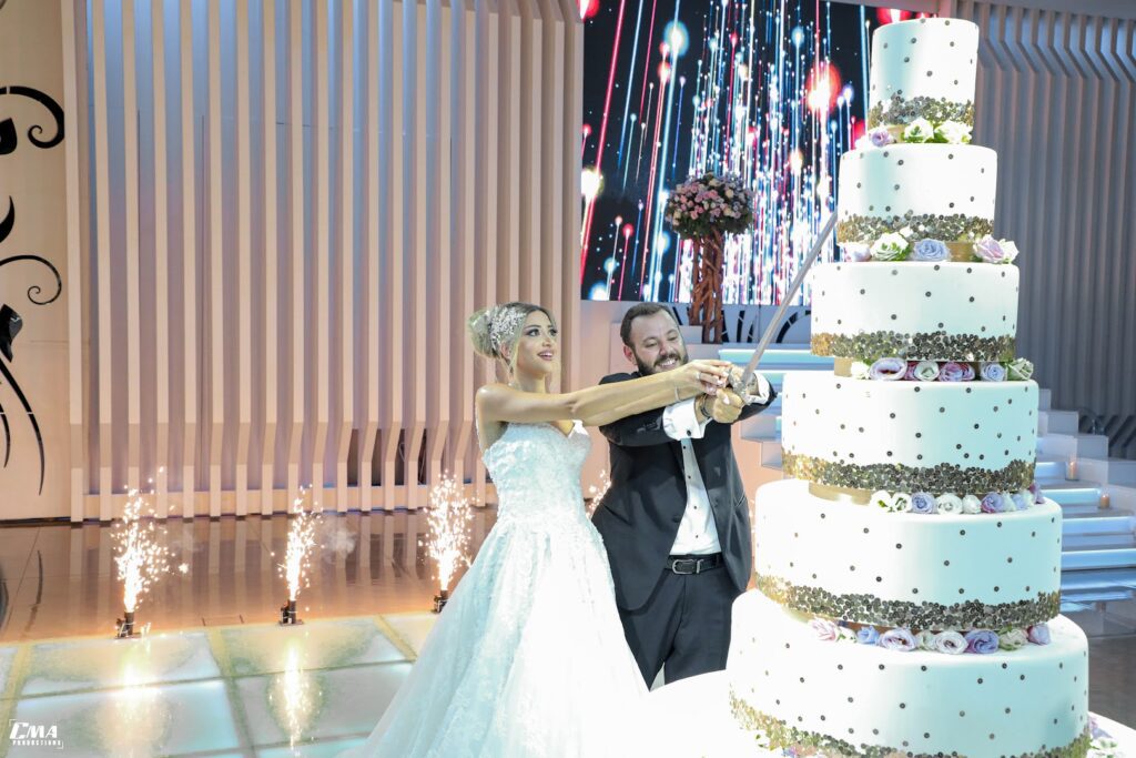 a man and woman cutting a wedding cake