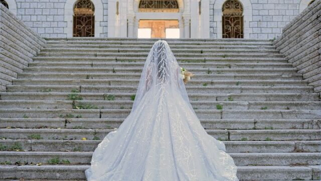 a woman in a wedding dress on stairs