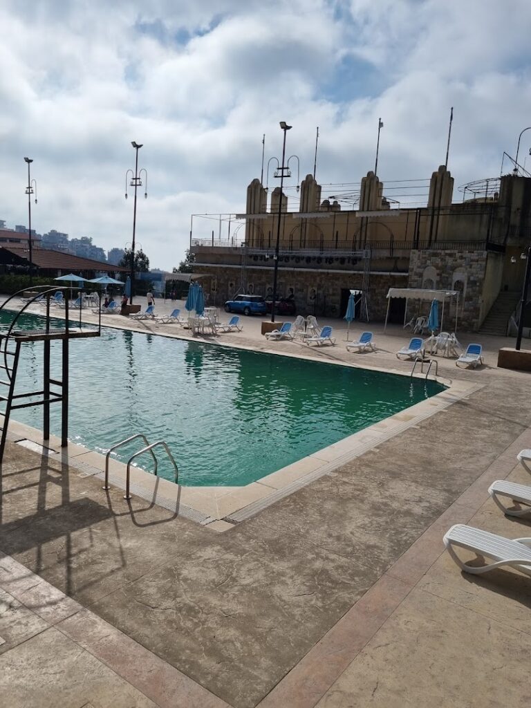 a pool with chairs and umbrellas