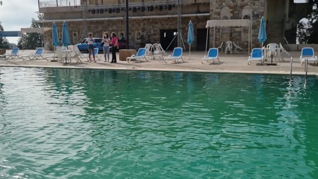 a pool with chairs and umbrellas