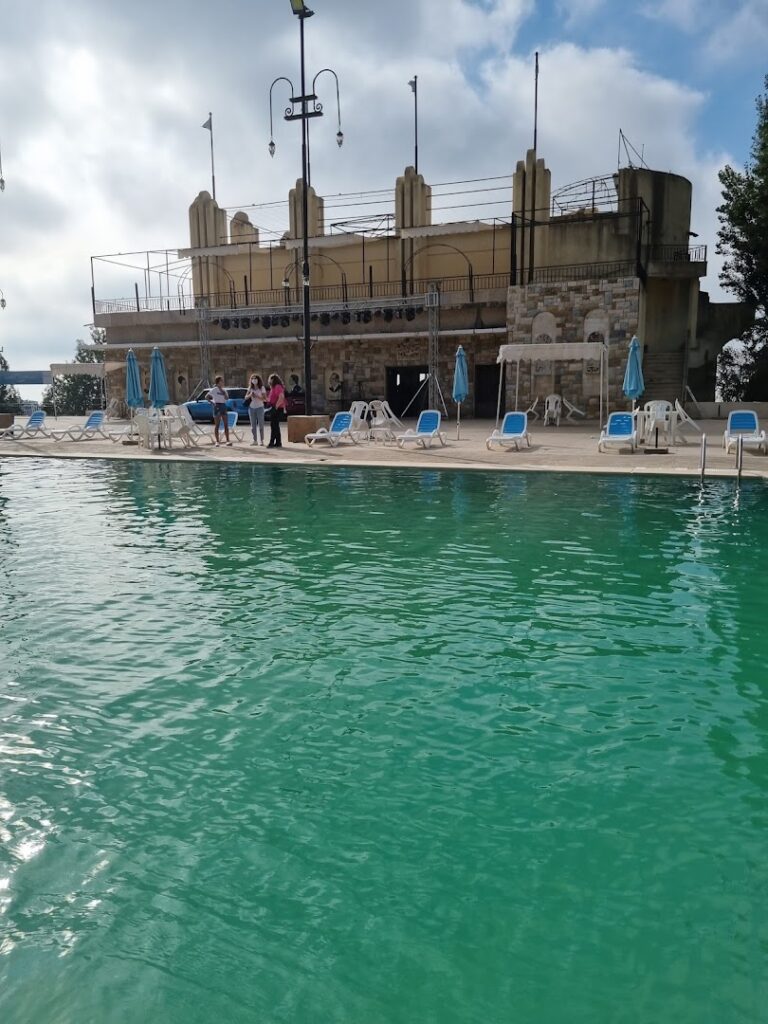 a pool with chairs and umbrellas