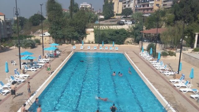 a pool with people swimming in it