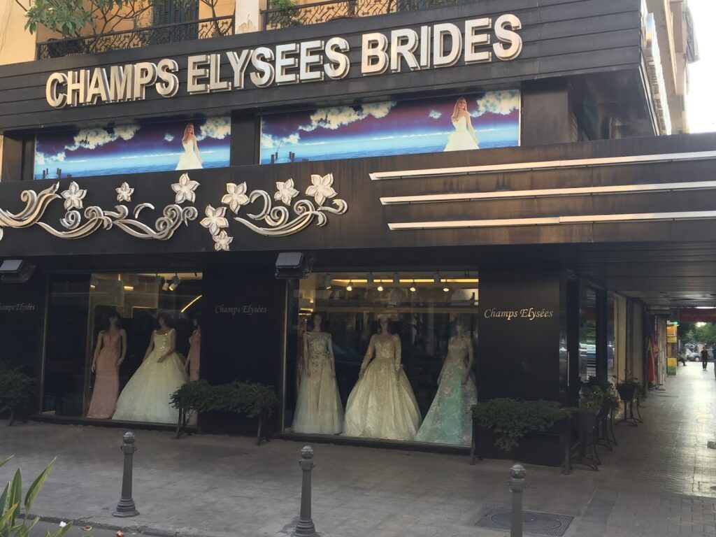 a store front with mannequins in dresses