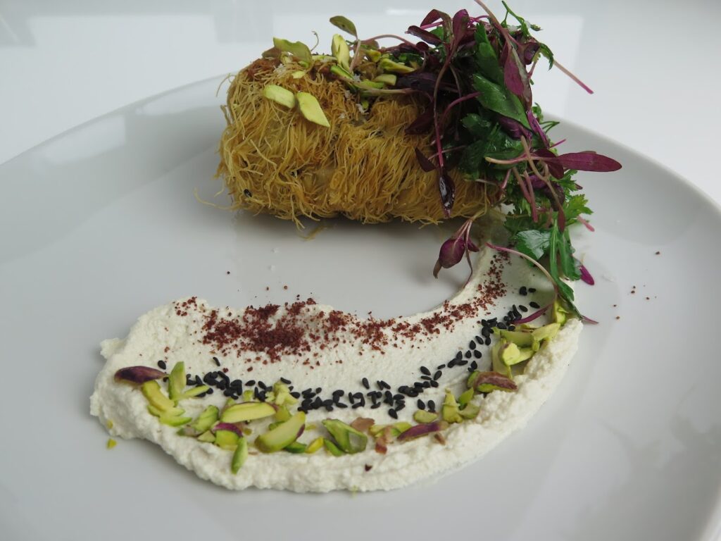 "A plate of food on a white surface, prepared by ChefXChange SAL."