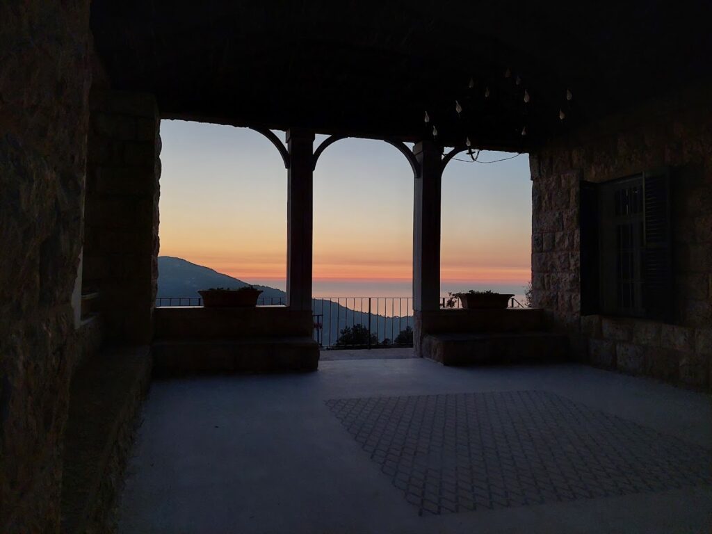 a building with a view of the ocean and mountains