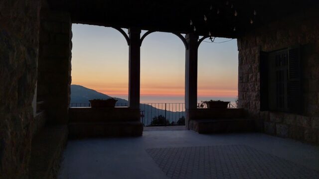 a building with a view of the ocean and mountains