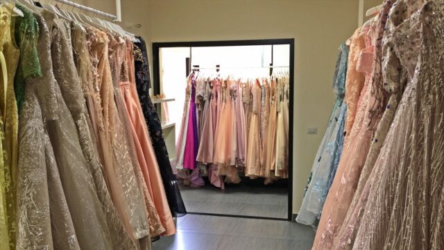 a room with many dresses on swingers