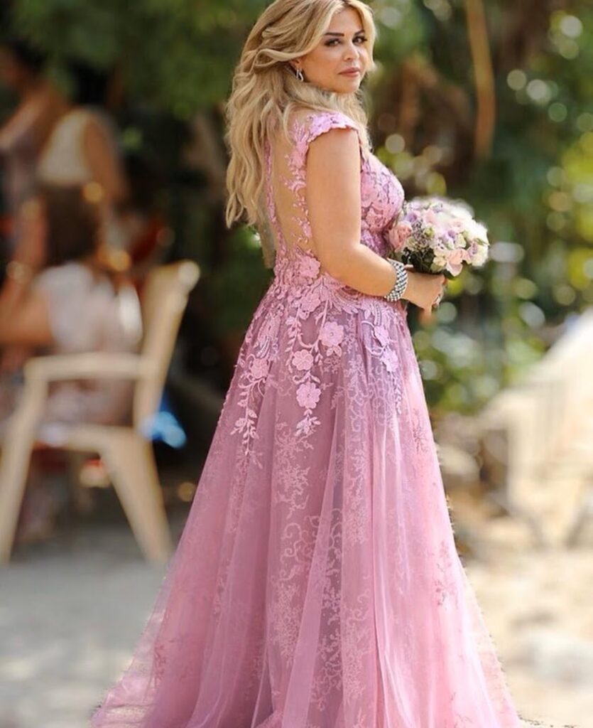 a woman in a pink dress holding a bouquet