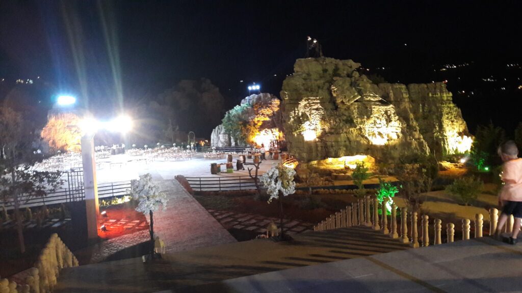 a large rock with lights at night