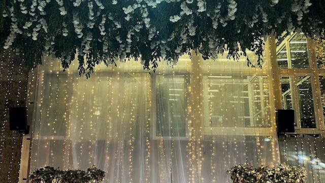 a table set up with flowers and lights