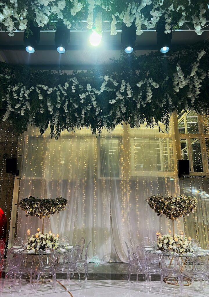 a table set up with flowers and lights