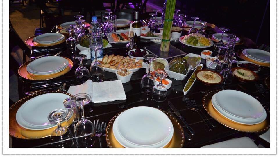 A table with plates and food on it featuring the keyword "Exotique Makhlouf".