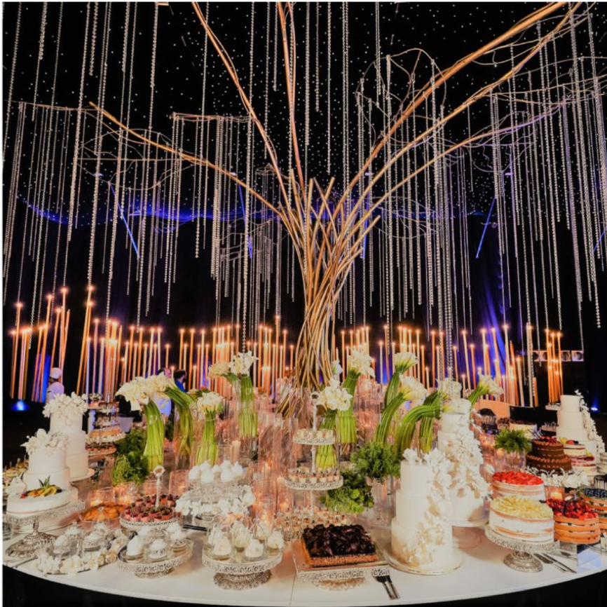 A table with food, lights, and Faqra Catering.